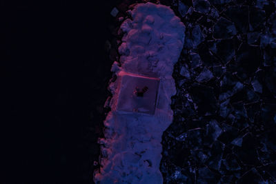 Close-up of rock against sky at night