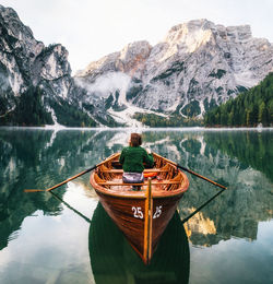 Rear view of man on boat in lake