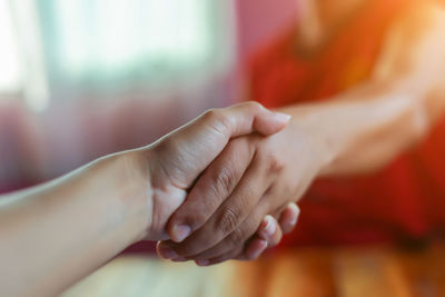 Close-up of people holding hands