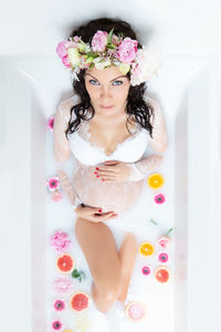 High angle view of woman with pink flower