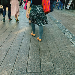 Low section of people walking on footpath