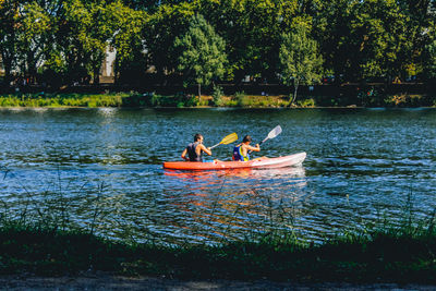 Friends kayaking in lake