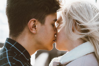 Close-up of couple kissing outdoors