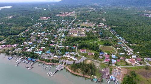 High angle view of town by sea against sky