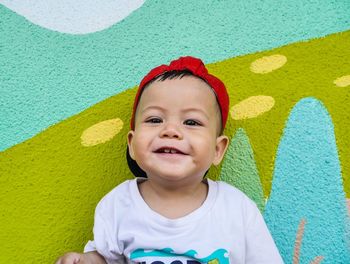 Portrait of cute boy against wall