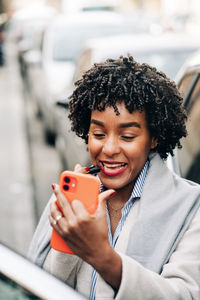 Portrait of smiling young man using mobile phone