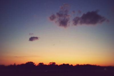 Low angle view of silhouette trees against sky at sunset