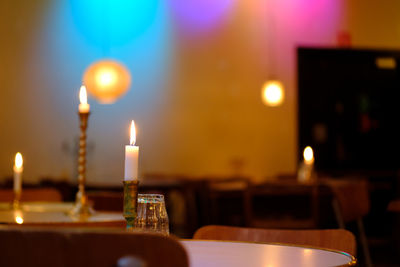 Close-up of illuminated tea light candles on table