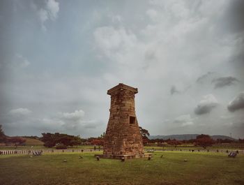Old ruins on field against sky