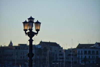 Street light in city at dusk