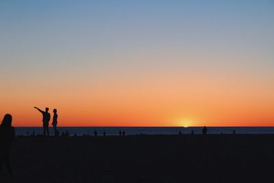 Silhouette of man playing on beach