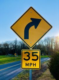 Road sign against sky