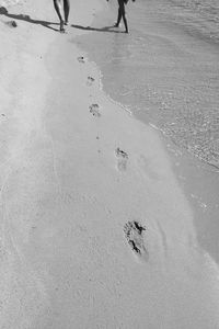 High angle view of footprints on sand at beach