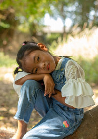 Portrait of teenage girl sitting outdoors