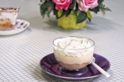 Close-up of taro cupcake coffee served on table