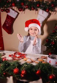 Portrait of smiling woman holding christmas tree