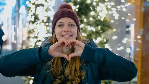 Portrait of smiling young woman in park during winter