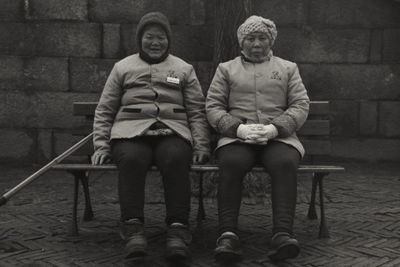 Portrait of friends sitting on seat