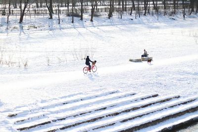 People skiing on snow covered landscape