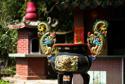 Sculpture on incense holder outside temple