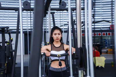 Young woman exercising in gym