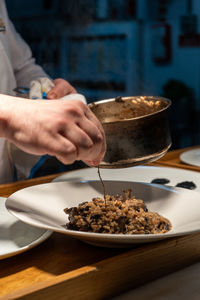 Midsection of person preparing food on table