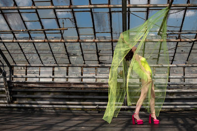 Low section of woman in a bodysuit dancing in the green house