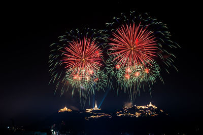 Low angle view of firework display at night