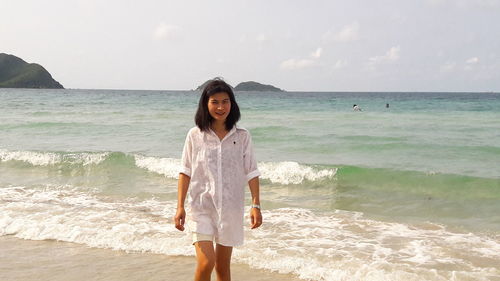 Portrait of woman standing on beach