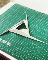 High angle view of arrow symbol on paper