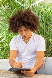 Portrait of young woman using mobile phone