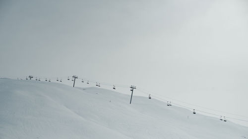 Scenic view of empty ski lifts