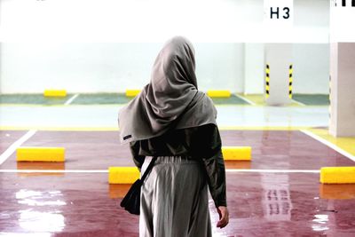 Rear view of woman with yellow umbrella