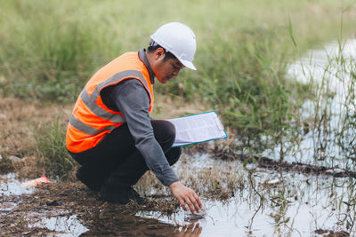 Side view of man working at park