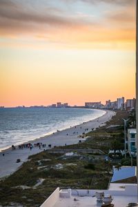 Scenic view of beach against sky during sunset