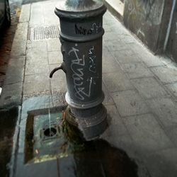 High angle view of old cross on sidewalk