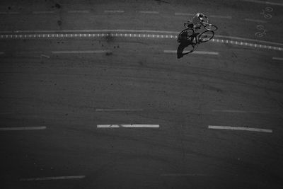 High angle view of man riding bicycle on street