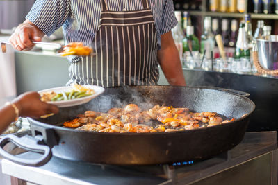 Midsection of man preparing food in kitchen