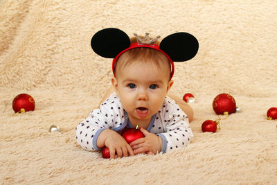 High angle view of girl by decoration on carpet