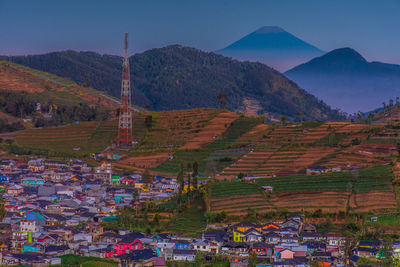 Aerial view of buildings and mountains against sky