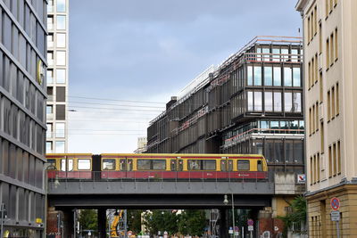 Low angle view of train against buildings in city