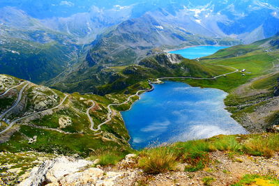 High angle view of lake and mountains against sky