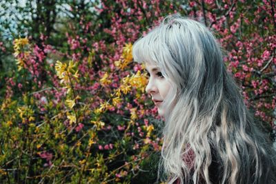 Close-up portrait of young woman with flowers