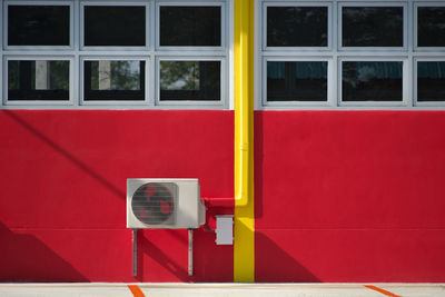 Red window on white building