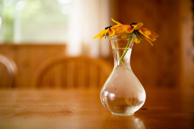 Close-up of yellow flower in vase on table