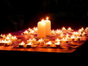 Close-up of illuminated candles in temple