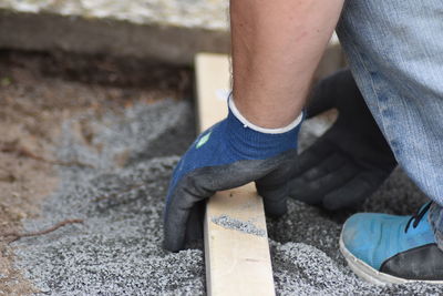 Low section of manual worker working at construction site