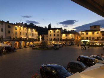 Cars on street amidst buildings in town