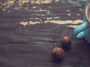 Close-up of hand holding ice cream on table