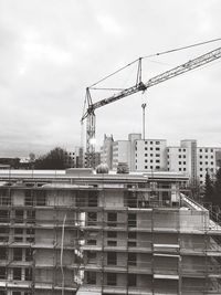 Construction site in city against sky